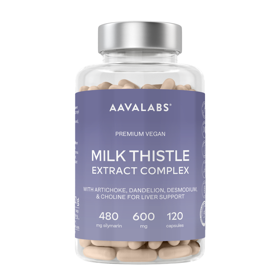 A clear supplement bottle filled with beige capsules, featuring a lavender label for AAVALABS Milk Thistle Extract Complex, with a silver cap, on a white background.