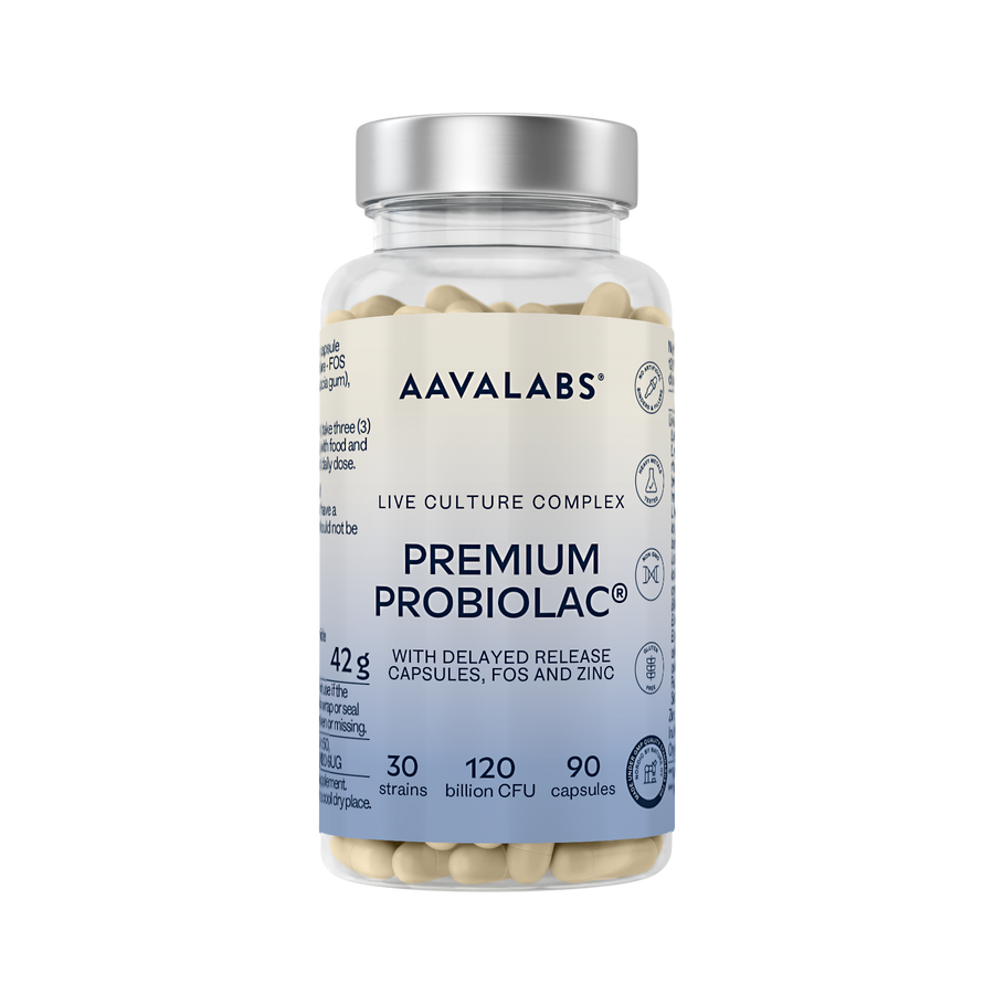 A clear plastic bottle of Aavalabs Premium Probiolac live culture complex with a silver cap and a white-to-blue label, filled with beige capsules, on a white background.