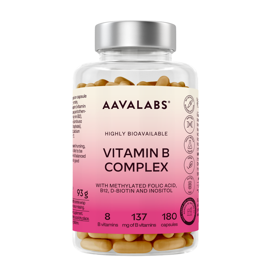 A clear plastic bottle of AAVALABS Vitamin B Complex capsules with a silver cap and a pink-to-cream label, showing the tan capsules inside.
