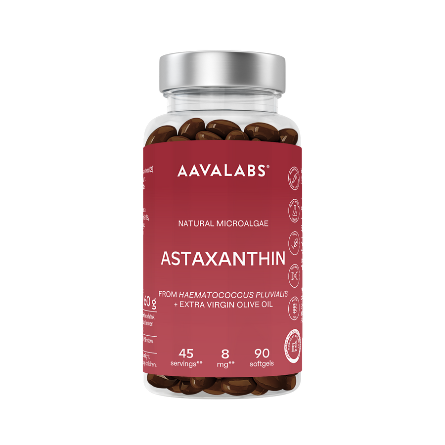 A bottle of AAVALABS Astaxanthin dietary supplements, featuring a dark red label and a metallic silver cap, filled with brown softgels.