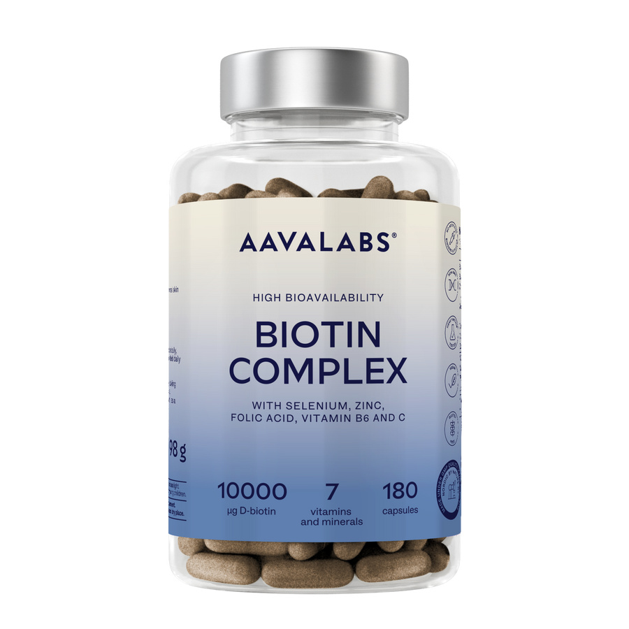 A clear plastic bottle of Aavalabs Biotin Complex dietary supplement capsules with a silver cap and a white-to-blue gradient label, shown on a plain white background.