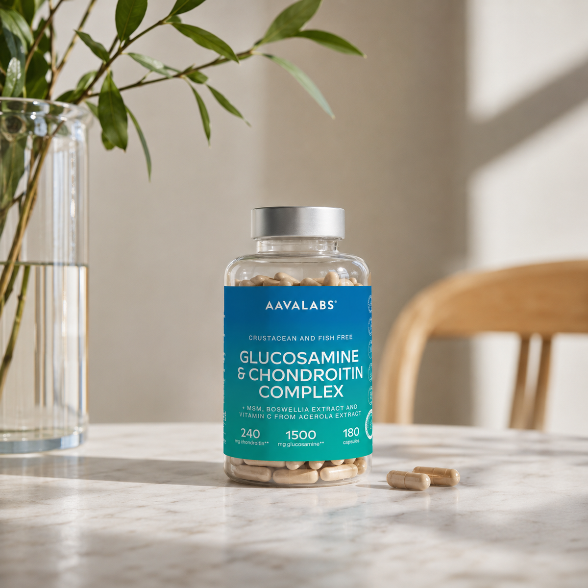 Bottle of Aavalabs Glucosamine & Chondroitin Complex on a table with a vase and plant in the background