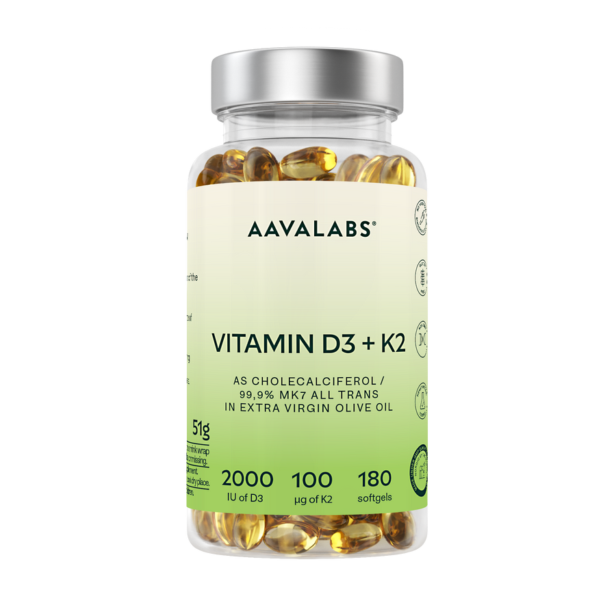 A clear plastic bottle of AAVALABS Vitamin D3 + K2 softgels with a silver cap and a light green-to-white label, filled with yellow-gold softgels, on a solid white background.