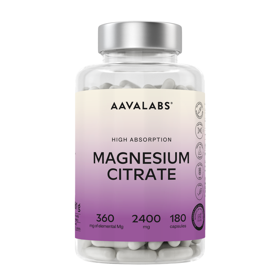 A bottle of Aavalabs Magnesium Citrate dietary supplement capsules, featuring a clear plastic bottle with a silver cap and a cream-to-purple gradient label.